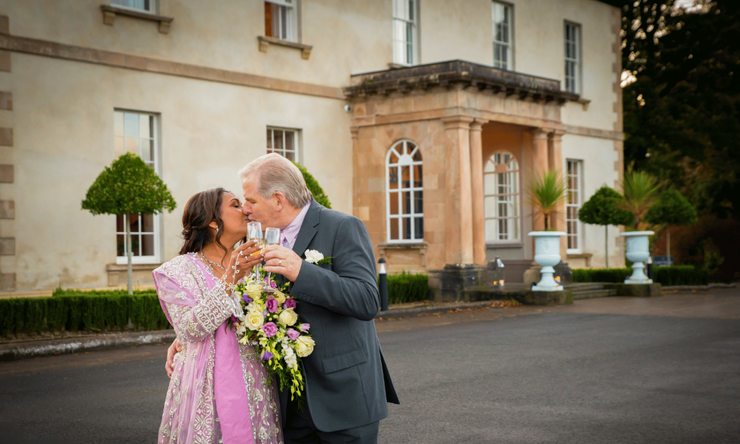 Couple kiss outside Rockhill House Estate